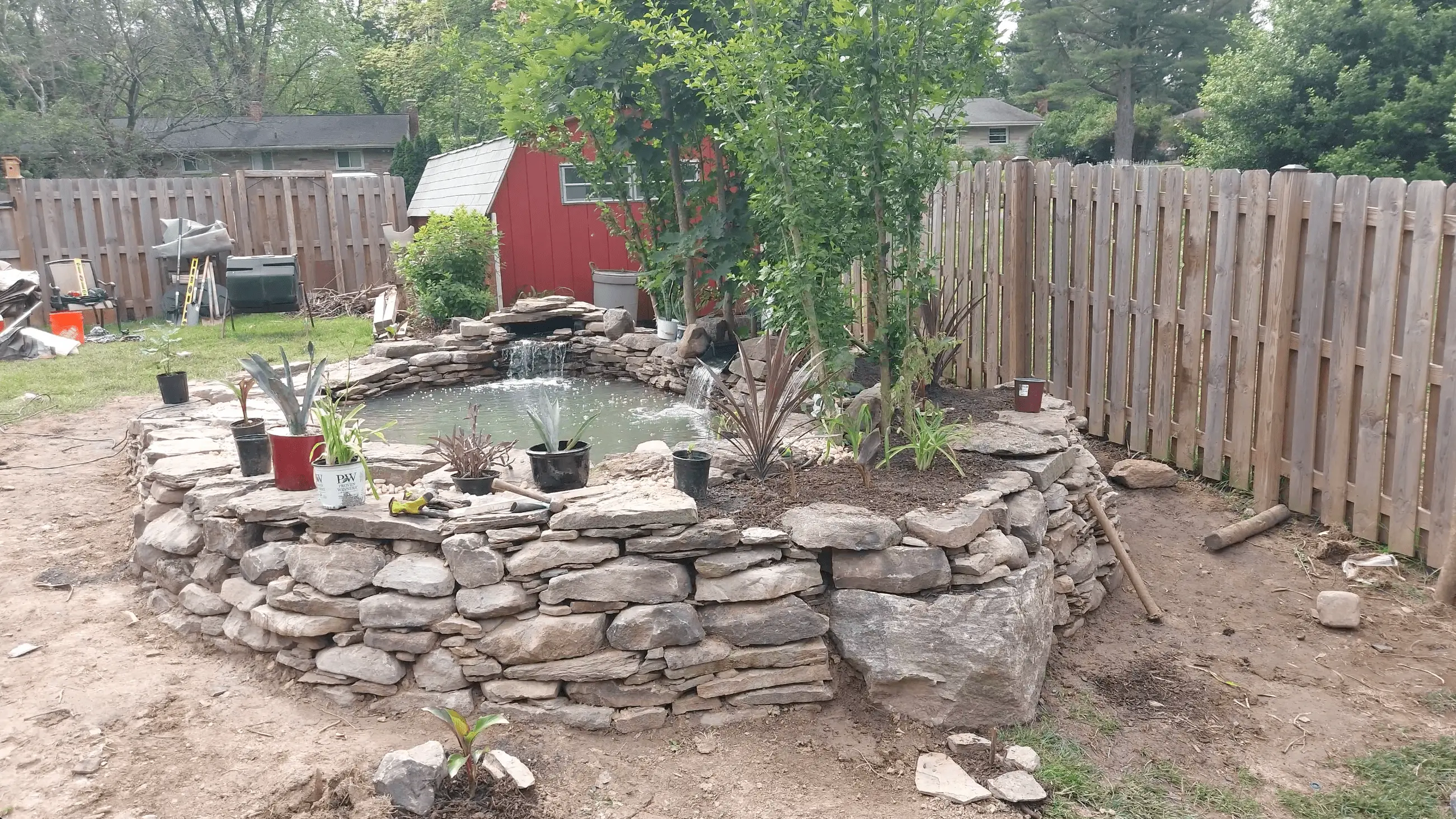 wide view photo of large pond with raised retaining wall