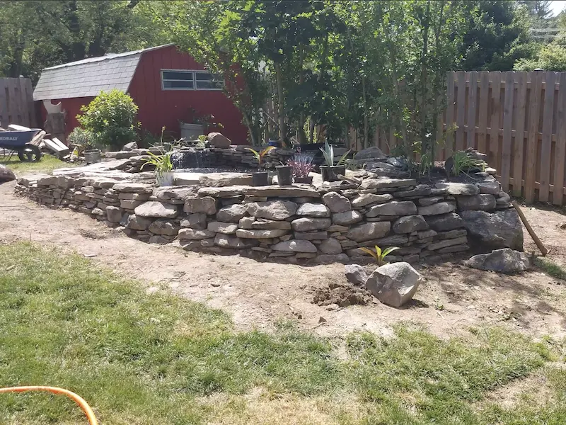 retaining wall for pond built on sloped yard