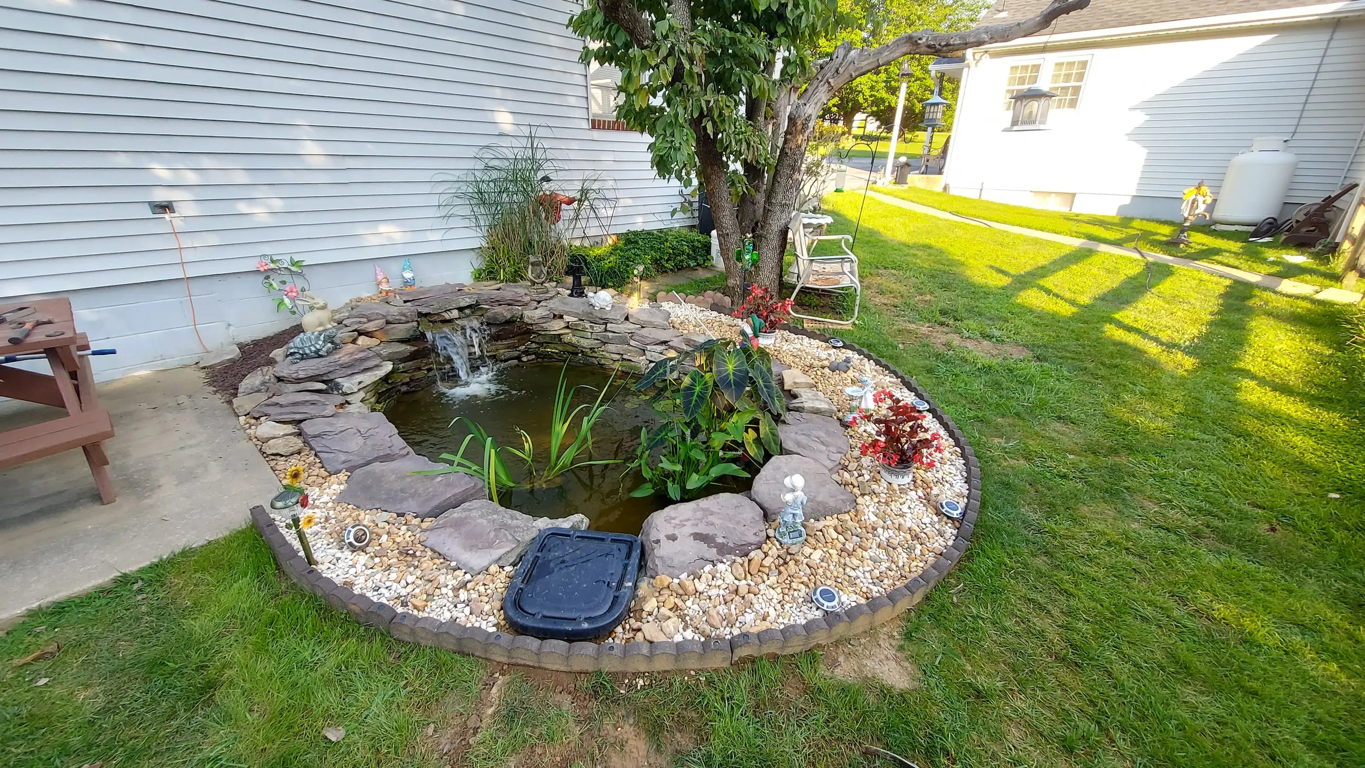 A koi pond built in Owings Mills, MD stocked with water lilies, elephant ears and irises. These plants help
						process nutrients inside a pond such as fish food and fish waste. Pond plants are vital components to
						ecoystem ponds as they naturally filter water and provide shade.
																																