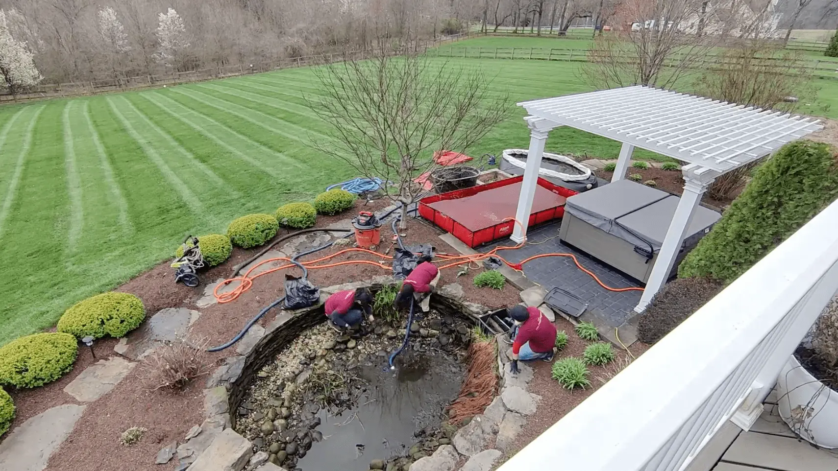 An aerial view of our maintenance team cleaning out a large 2000 gallon pond. They drained the clean pond water into two large storage tanks. Saving the water allows us to use it to rinse and clean the pond. We also use the clean pond water to refill the pond at the end of the job. 
