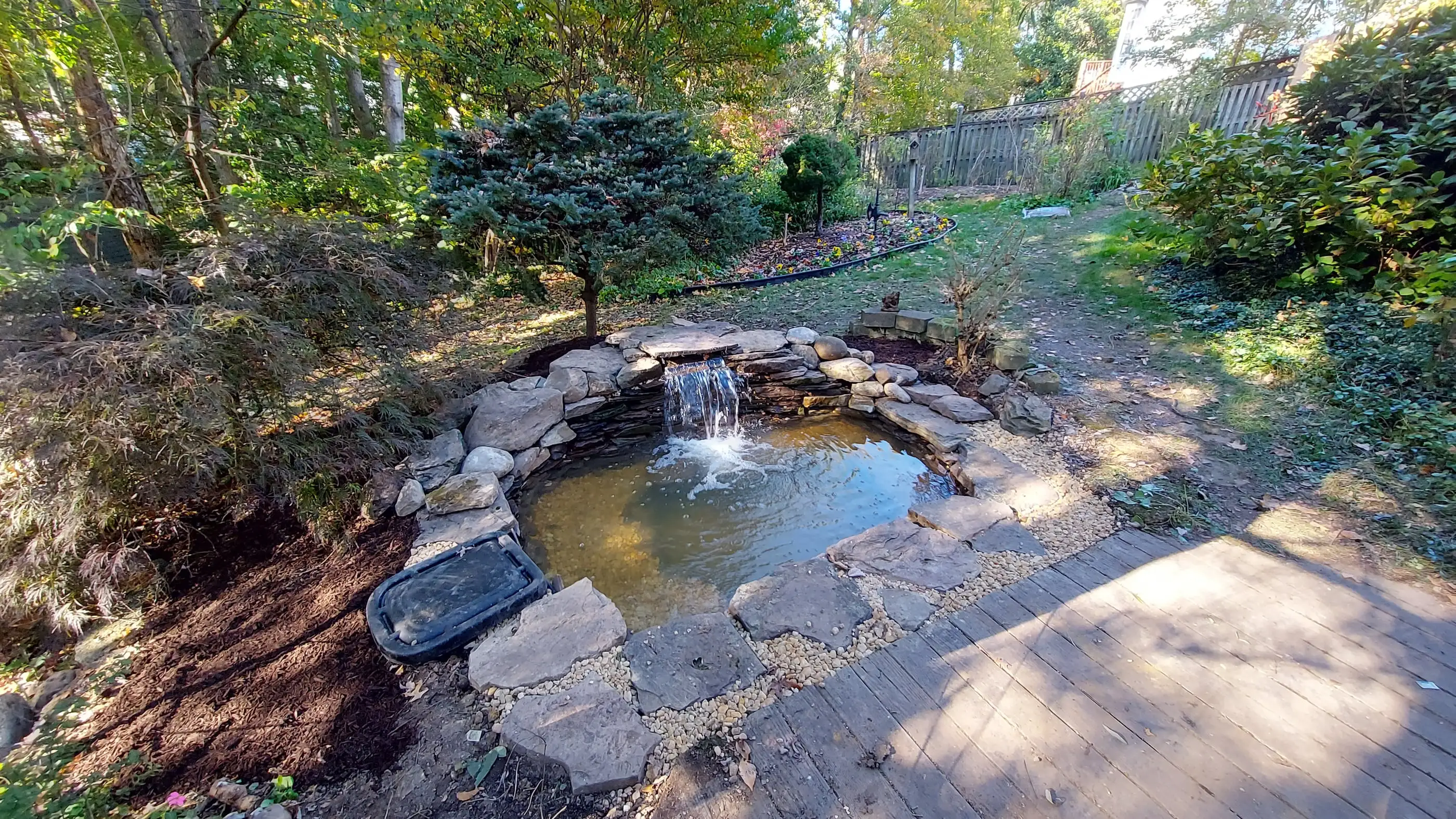 Koi pond built flush with wooden patio