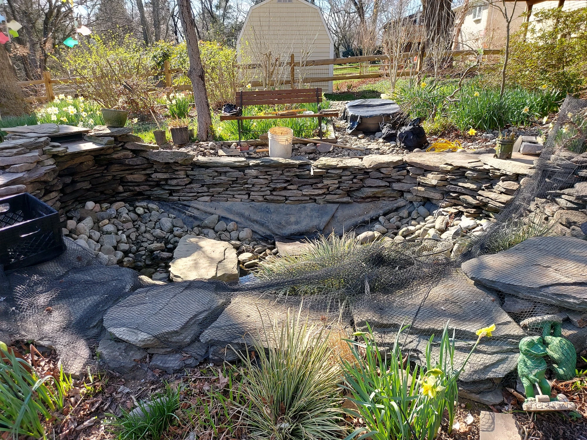 pond wall rebuilt with pa fieldstone using dry stack retaining wall construction method